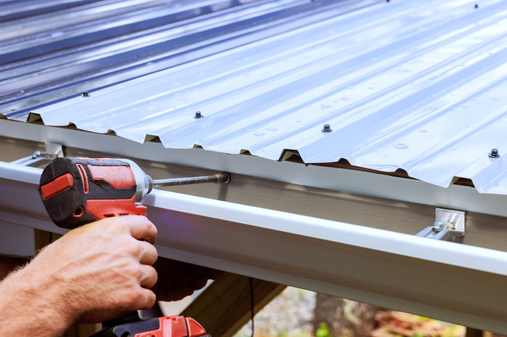Gutter installation on a metal roof