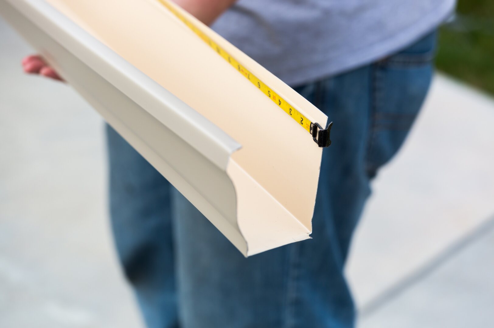 Gutter profile being measured during on-site fabrication