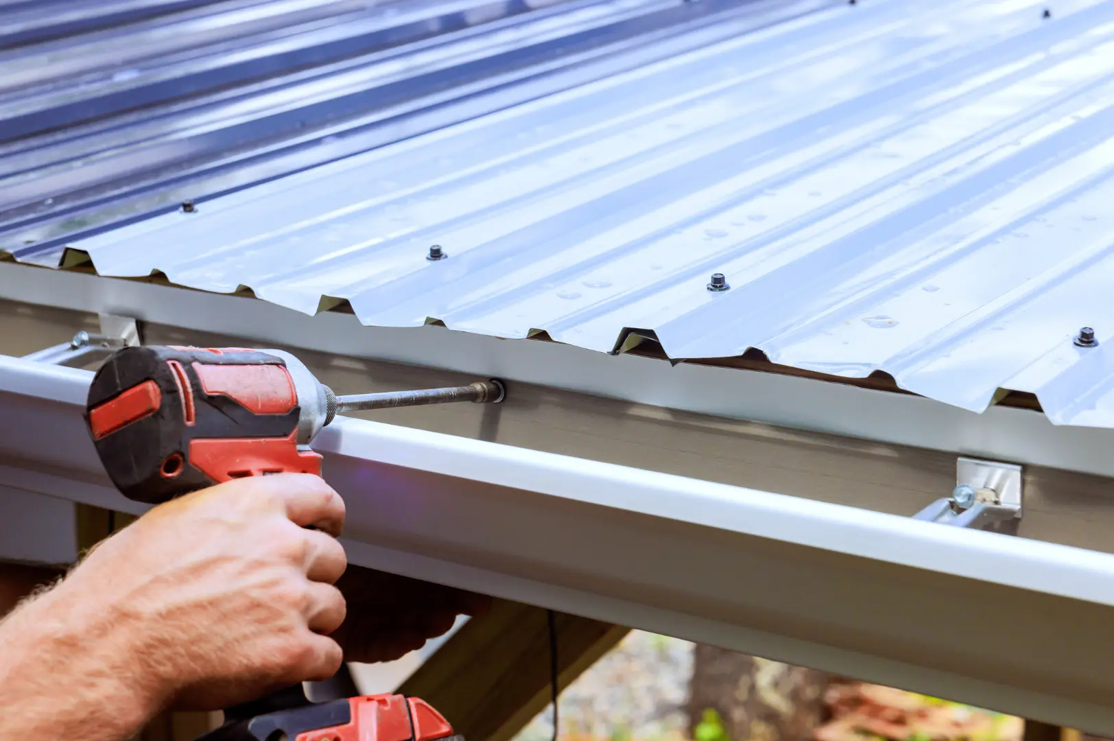 Gutter installation on a metal roof