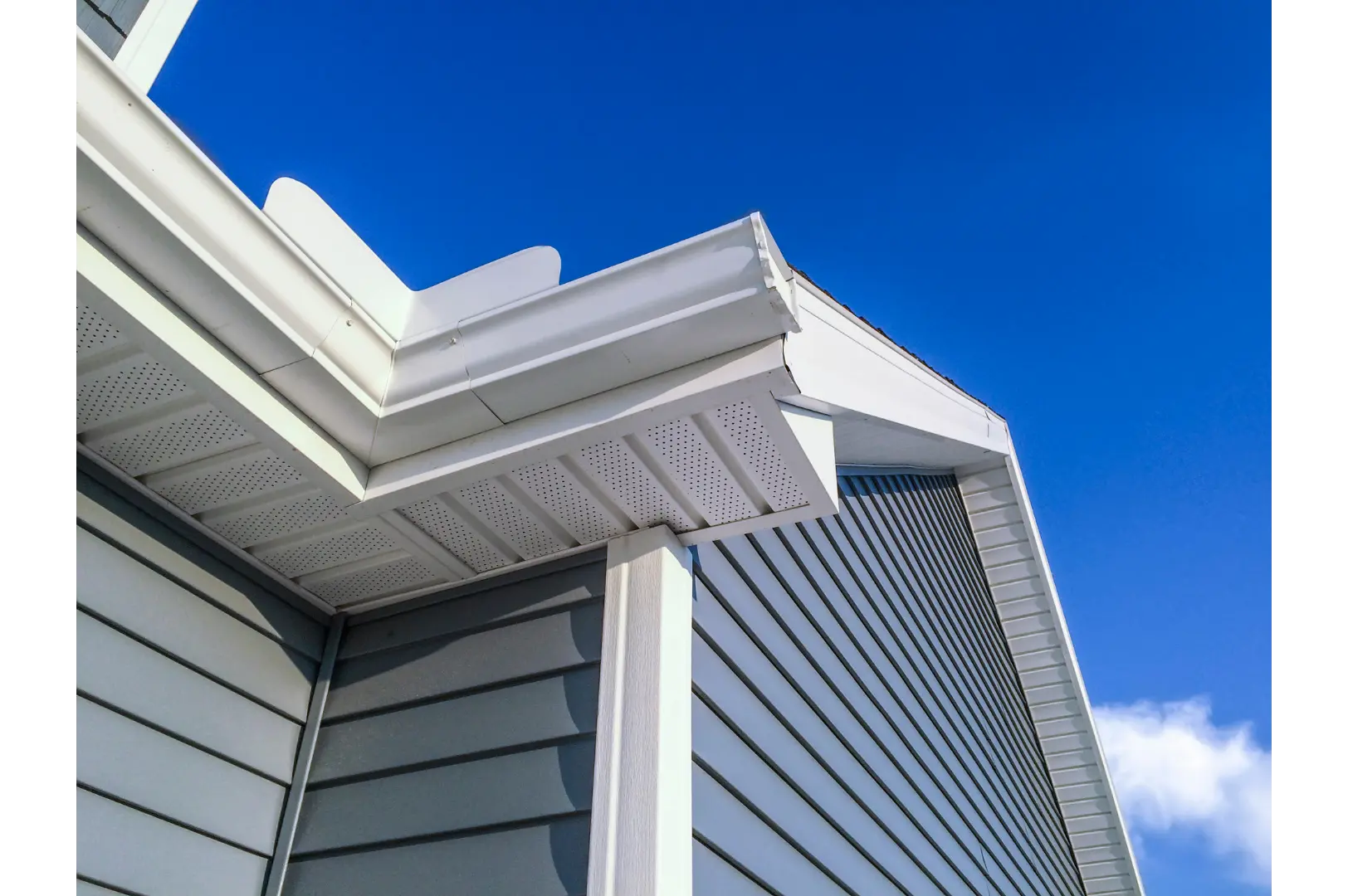 White gutter and fascia detail against a deep blue sky