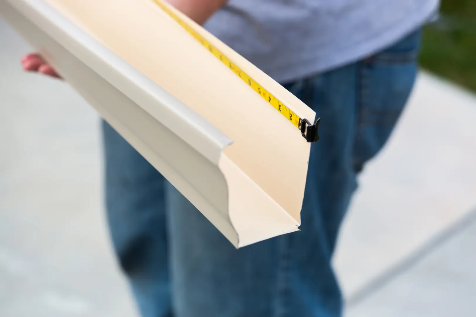 Gutter profile being measured during on-site fabrication