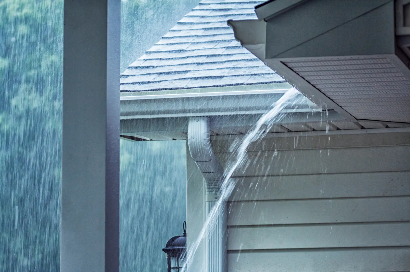 Gutter carrying heavy rainwater from a residential roof