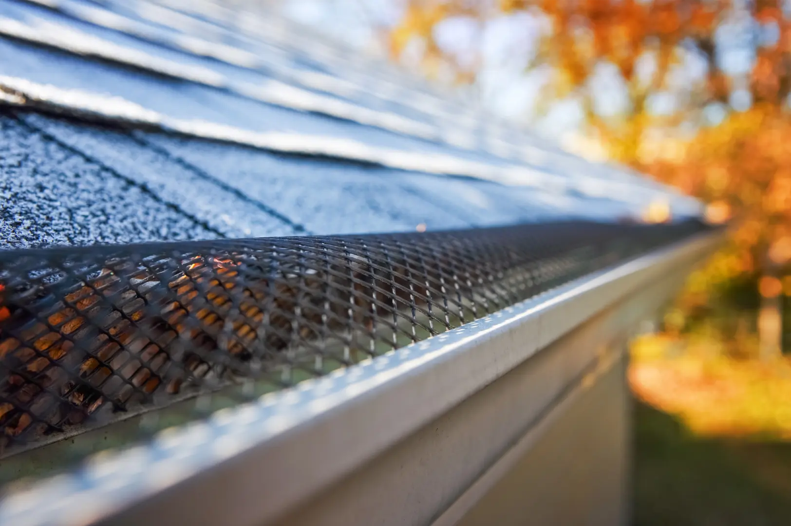 Leaf guard fitted neatly over a residential gutter